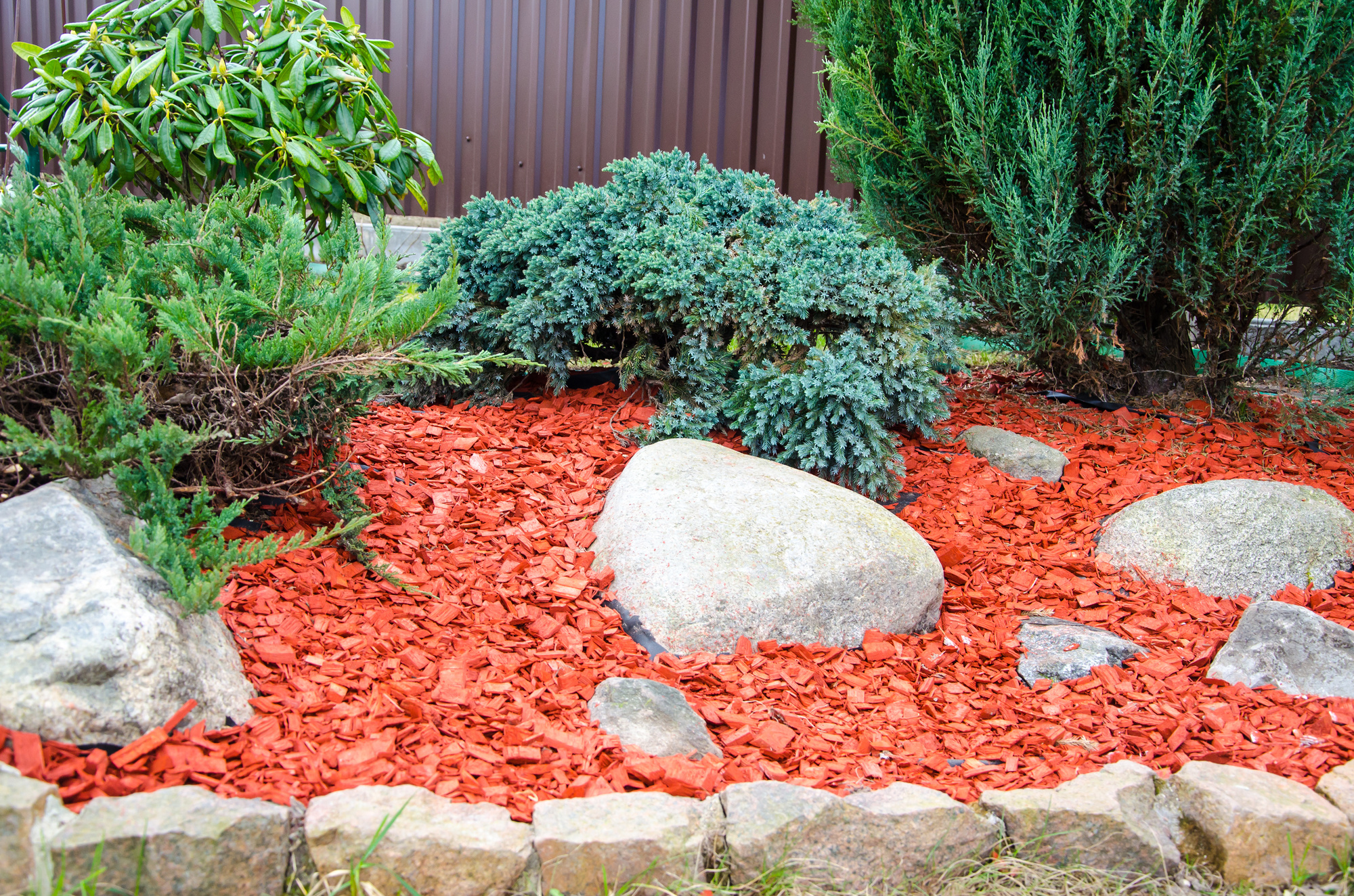 Image of Pile of red wood chips in a garden